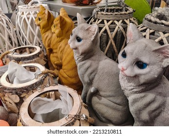 Ceramic Cat Souvenir Shop. Cat Figurines. Home Decorations. Red And Gray Ceramic Cats Among The Vases. The Cat Symbol