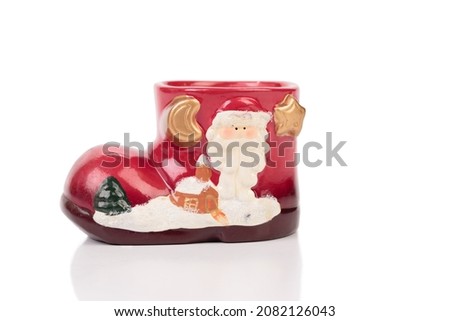 Ceramic Christmas boot for gifts. Isolated over white background. Close-up.