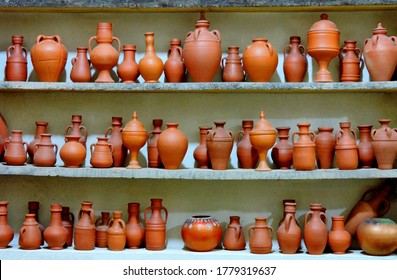 Ceramic Clay Terracotta Jug, Pot, Vase, Kitchen Souvenirs On Shelf At Street Handicraft Pottery Shop. Old Earthen Terracotta Jug, Pot, Clay Jar Pattern In Store. Clay Brown Various Ceramic Pot & Jugs