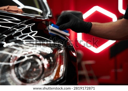 Ceramic coating application delivers scratch resistance by applying liquid glass sealant to car hood and applying ceramic paint protection to restore and preserve vehicle aesthetics.