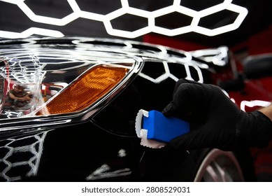 Ceramic coating application features applying liquid glass sealant to a black car hood for scratch resistance and applying ceramic paint protection to restore vehicle aesthetics.
