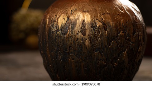 Ceramic copper vase in a dark interior - Shutterstock ID 1909393078