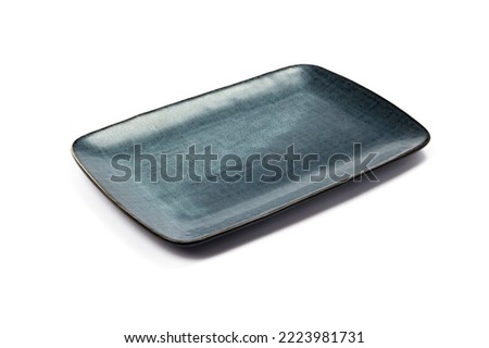 ceramic dark blue flat square plate with black blotches (dots, paint splashes, spots) close-up on white background