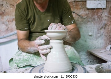 Ceramic dishes in working process. Creating ceramic pieces. Tradicional ceramic factory in spain. Father teaching the art of ceramic making.