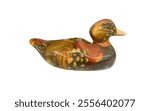 A ceramic duck figurine. It is painted in a colorful, abstract style with a mix of brown, orange, and yellow colors. The duck appears to be inspired by nature, with patterns resembling flowers.