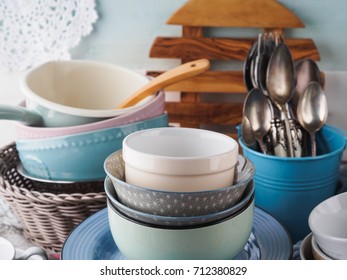 Ceramic and enamel crockery tableware on wooden background. Pastel vintage colors - Shutterstock ID 712380829