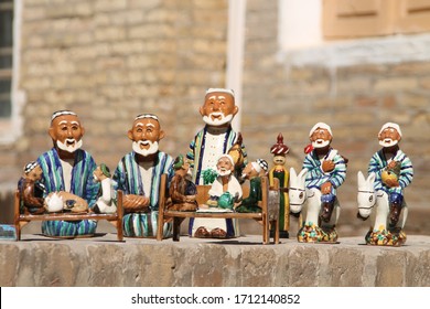 Ceramic figures of Uzbek old men in traditional clothes. Souvenirs at market in Khiva. Uzbekistan