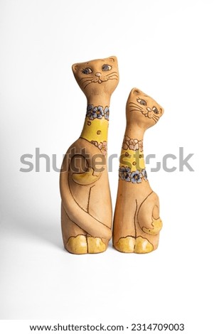 Ceramic figurine of two cats, hand-painted. Vintage statuette cats. On a white background.