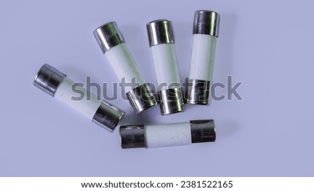 Ceramic fuse, metal top and bottom, white background, macro photography