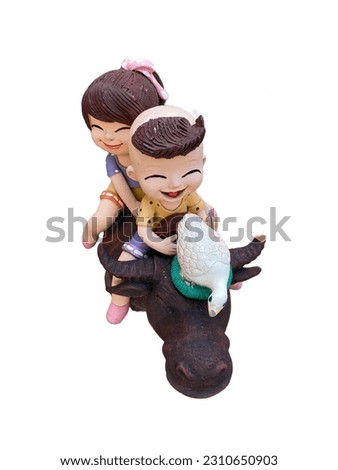 ceramic girl and boy riding on a buffalo