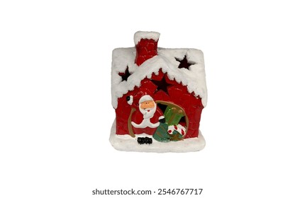 A ceramic house-shaped decoration. It is red with a white snowy roof and a chimney. A small Santa Claus figure is visible inside the house, holding a gift. It has cut-out star shapes on the roof. - Powered by Shutterstock