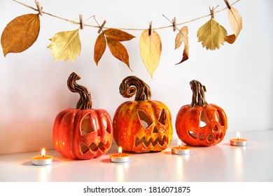 Ceramic Jack Lanterns And Autumn Leaves Garland. Halloween Composition. Home Decor.