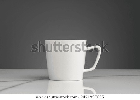 Ceramic mug on marble table on gray background