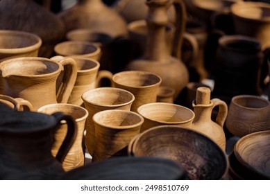 Ceramic national Ukrainian dishes demonstrated at local fair. Close-up of diverse clay dishes for sale at pottery market - Powered by Shutterstock