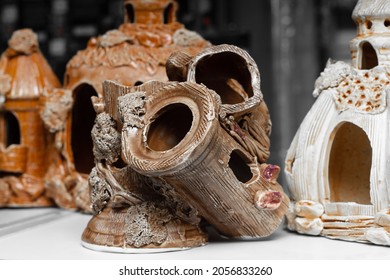 Ceramic Painted Antique Grottoes For Fish In An Aquarium On The Counter Of A Pet Store