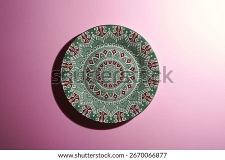 Ceramic plate with decorative pattern in the form of mandala.