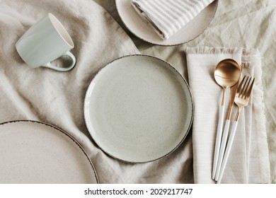 Ceramic plates mockup on  modern minimal table place setting neutral beige color top view.  Space for text or menu .Scandinavian style tableware. Business food brand template.