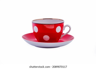 Ceramic red cup with white polka dots on saucer isolated on white background. Copy space. - Powered by Shutterstock