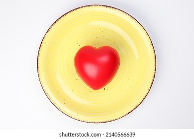 Ceramic Retro Yellow Food Plate With Three Dimension 3d Red Hart Symbol On Top Of It White Background Copy Text Space Top View