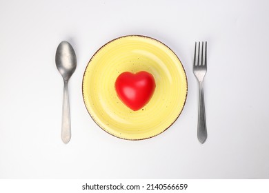 Ceramic Retro Yellow Food Plate Fork Spoon With Three Dimension 3d Red Hart Symbol On Top Of It White Background Copy Text Space Top View