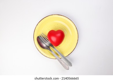 Ceramic Retro Yellow Food Plate Fork Spoon With Three Dimension 3d Red Hart Symbol On Top Of It White Background Copy Text Space Top View