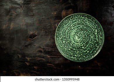 Ceramic Rustic Plate, Cutlery On On The Old Black Table Top View. Table Setting. Aerial View, With Copy Space.