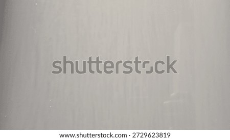 The ceramic surface is light greyish white with faint veetical lines.