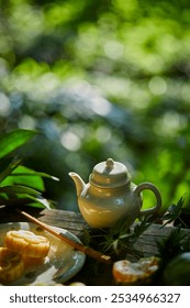 Ceramic teapot on rustic table, surrounded by lush greenery, basking in soft, dappled sunlight.