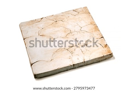 Ceramic tile with cracks and chips isolated on white background