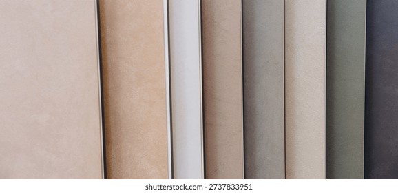 Ceramic tile samples showcasing a range of earth tones and textures for flooring and wall covering in residential and commercial spaces