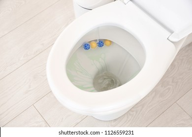 Ceramic toilet bowl with detergent in modern bathroom