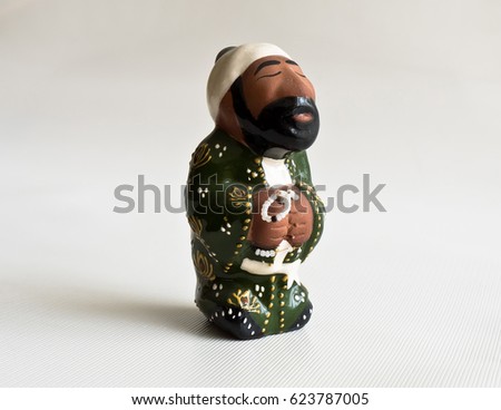 Ceramic toy Uzbek on a white background