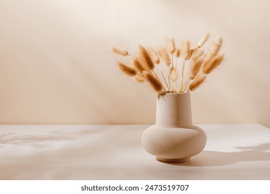 Ceramic vase beautiful composition on the table with shadows, vase with bunny tail grass. Aesthetic still life, cozy home decoration, scandinavian interior for design, poster or print