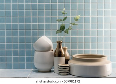 Ceramic Vase And Bowl Decoration In A Bathroom With Blue Mosaic Tile