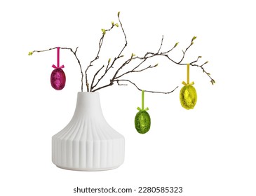 Ceramic vase and spring twigs with Easter eggs isolated on white background. Springtime interior decoration. 