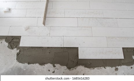 Ceramic wood effect tiles and tools for tiler on the floor  unfinished laying floor tiles  Floor tiles installation