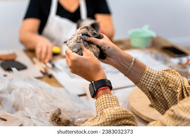 Ceramic works. Close-up of a middle-aged woman's hands kneading clay. - Powered by Shutterstock