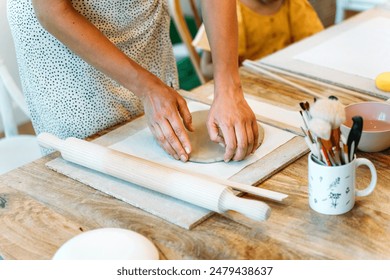 Ceramic workshop. Crafting clay fish shapes in a pottery class - Powered by Shutterstock