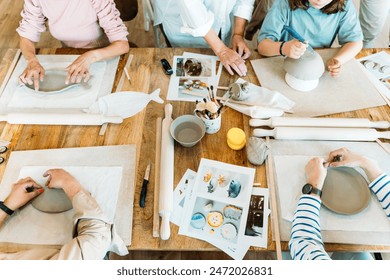 Ceramic workshop. Group of friends crafting a ceramic plate. - Powered by Shutterstock