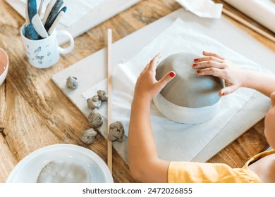 Ceramic workshop. Group of friends crafting a ceramic plate. - Powered by Shutterstock