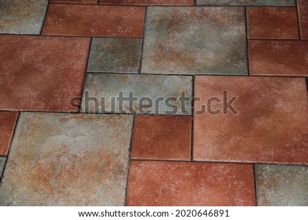 Ceramic-granite gray-brown tile. Square multi-colored floor tiles. Backgrounds