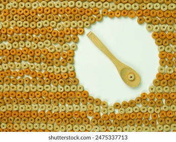 Cereal background multigrain hoops texture. Organised in amusing rows with subject isolated. High-key lighting, plain white background with warm colors. Closeup of cereal using a macro lens. Photo. 