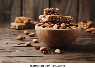 Cereal bar with almond and berry on thw wooden table, selective focus