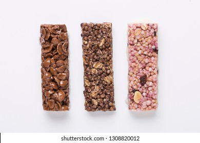 Cereal Bars On Color Background, Sugar, Chocolate And Muesli, Dried Fruits, Corn Flakes With Cocoa