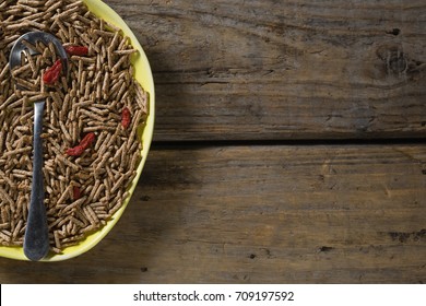 Cereal bran sticks with spoon in plate on wooden table - Powered by Shutterstock