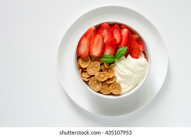 Cereal Or Corn Flakes, Strawberries And Yogurt Bowl For Breakfast, View From High Angle