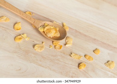 Cereal Cornflakes Spilling Out From The Wood Spoon To Wood Floor