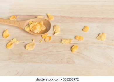 Cereal Cornflakes Spilling Out From The Wood Spoon To Wood Floor