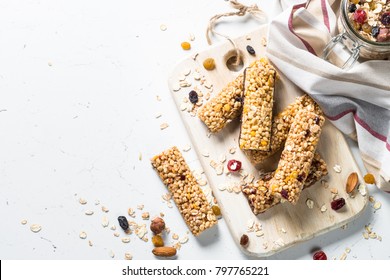 Cereal Granola Bar With Nuts, Fruit And Berries On A White Stone Table. Healthy Sweet Dessert Snack. Top View Copy Space.