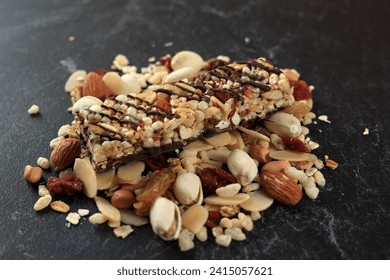 Cereal Healthy Snack. Granola Bar with Nuts and Dry Fruit Berries. Diet Food on Black Marble Table  - Powered by Shutterstock